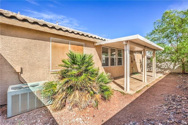 202 Twin Creek St, Henderson, NV 89074 - view of side of property featuring stucco siding, a patio, and cooling unit