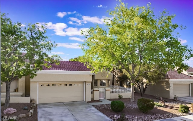 2553 Showcase Dr, Las Vegas, NV 89134 - view of front of house featuring an attached garage, stucco siding, a fenced front yard, and concrete driveway