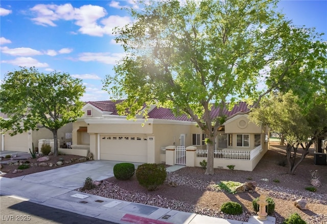 2553 Showcase Dr, Las Vegas, NV 89134 - view of front of home with a garage, concrete driveway, a fenced front yard, a tile roof, and stucco siding