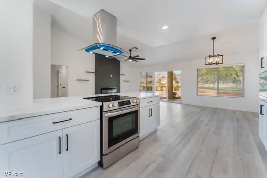 2553 Showcase Dr, Las Vegas, NV 89134 - kitchen featuring stainless steel range with electric stovetop, island exhaust hood, white cabinets, and a chandelier