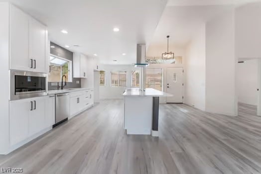 2553 Showcase Dr, Las Vegas, NV 89134 - kitchen with appliances with stainless steel finishes, white cabinets, light wood-style floors, light countertops, and recessed lighting