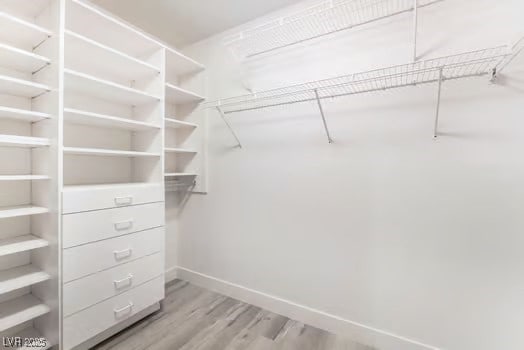 2553 Showcase Dr, Las Vegas, NV 89134 - spacious closet with light wood finished floors