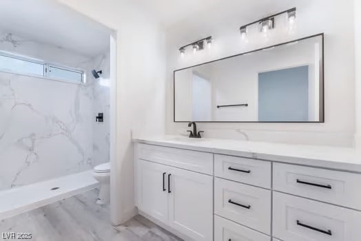 2553 Showcase Dr, Las Vegas, NV 89134 - bathroom featuring toilet, vanity, and a marble finish shower