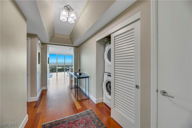 222 Karen Ave Unit 3307, Las Vegas, NV 89109 - laundry room featuring stacked washing machine and dryer, wood finished floors, and baseboards