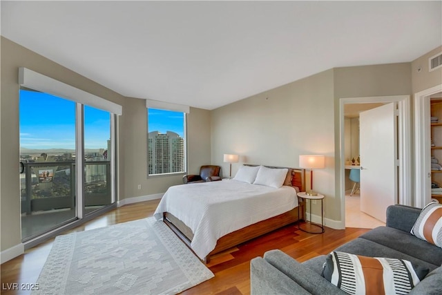 222 Karen Ave Unit 3307, Las Vegas, NV 89109 - bedroom featuring access to exterior, wood finished floors, and baseboards