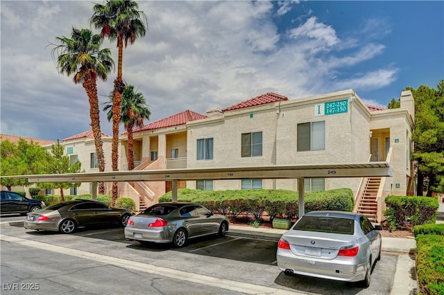 5000 Red Rock St Unit 248, Las Vegas, NV 89118 - view of building exterior with stairs and covered parking