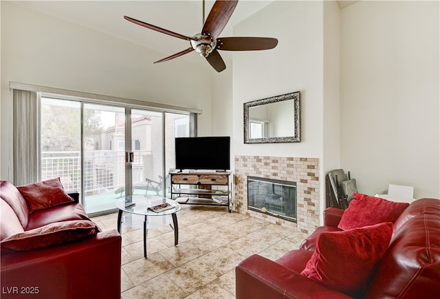 5000 Red Rock St Unit 248, Las Vegas, NV 89118 - living room with a ceiling fan, tile patterned flooring, a tiled fireplace, and high vaulted ceiling