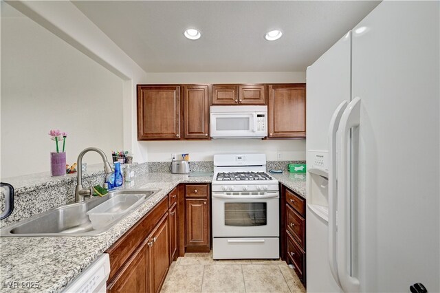 5000 Red Rock St Unit 248, Las Vegas, NV 89118 - kitchen with white appliances, light countertops, brown cabinetry, light tile patterned flooring, and recessed lighting