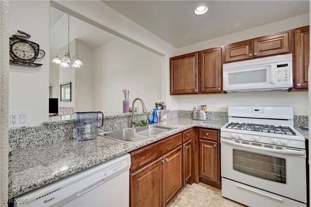 5000 Red Rock St Unit 248, Las Vegas, NV 89118 - kitchen featuring white appliances, brown cabinetry, a chandelier, light tile patterned floors, and recessed lighting