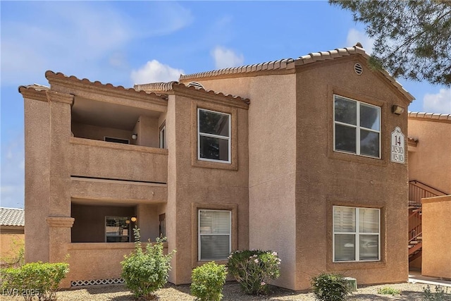 1150 N Buffalo Dr Unit 2025, Las Vegas, NV 89128 - view of front facade featuring stucco siding, a tiled roof, and stairs