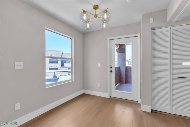 1150 N Buffalo Dr Unit 2025, Las Vegas, NV 89128 - unfurnished dining area with a chandelier and wood finished floors