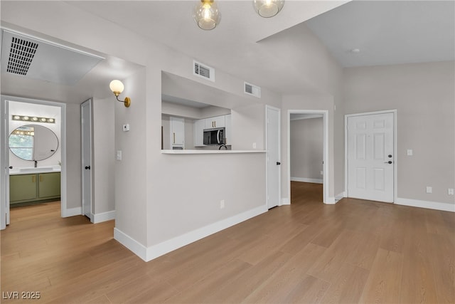 1150 N Buffalo Dr Unit 2025, Las Vegas, NV 89128 - unfurnished living room featuring light wood-type flooring