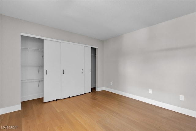1150 N Buffalo Dr Unit 2025, Las Vegas, NV 89128 - unfurnished bedroom featuring light wood-style floors and multiple closets
