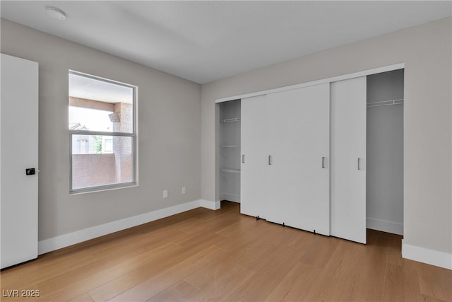 1150 N Buffalo Dr Unit 2025, Las Vegas, NV 89128 - unfurnished bedroom featuring baseboards and light wood-type flooring