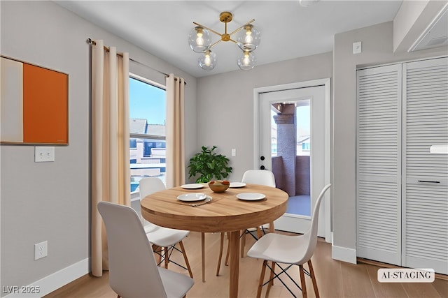 1150 N Buffalo Dr Unit 2025, Las Vegas, NV 89128 - dining space featuring light wood-type flooring and a chandelier