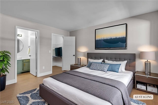 1150 N Buffalo Dr Unit 2025, Las Vegas, NV 89128 - bedroom with a walk in closet, wood finished floors, and ensuite bathroom