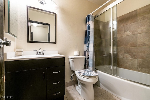3890 Lancome St, Las Vegas, NV 89115 - full bathroom with toilet, vanity, bath / shower combo with glass door, tile patterned floors, and a textured wall