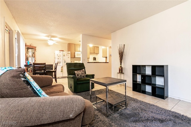 3890 Lancome St, Las Vegas, NV 89115 - living room featuring tile patterned floors, ceiling fan, and a textured ceiling