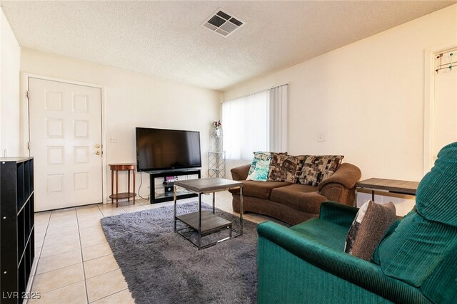 3890 Lancome St, Las Vegas, NV 89115 - living area with light tile patterned floors and a textured ceiling