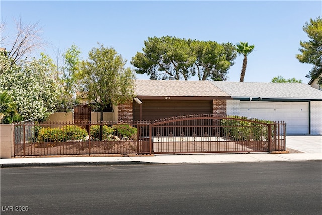 3890 Lancome St, Las Vegas, NV 89115 - ranch-style home featuring brick siding, a garage, driveway, and a gate