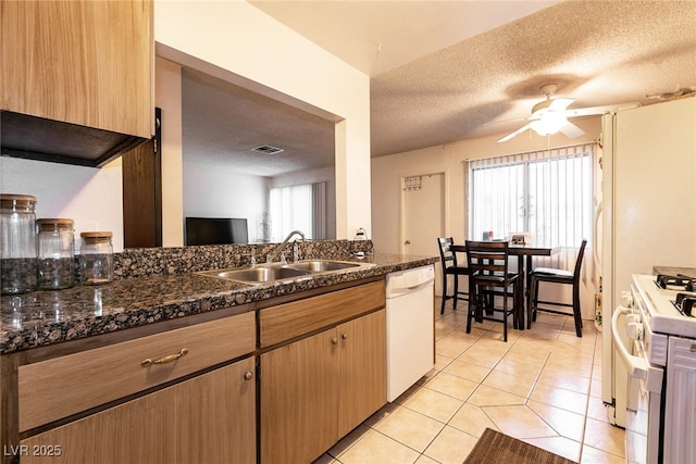 3890 Lancome St, Las Vegas, NV 89115 - kitchen with white appliances, a sink, a textured ceiling, light tile patterned floors, and ceiling fan