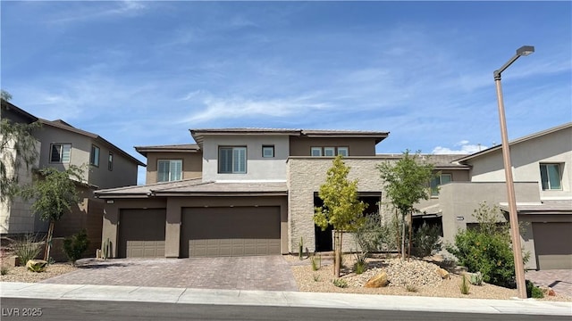754 Agate Hills St, Las Vegas, NV 89138 - view of front of property featuring stucco siding, an attached garage, and driveway