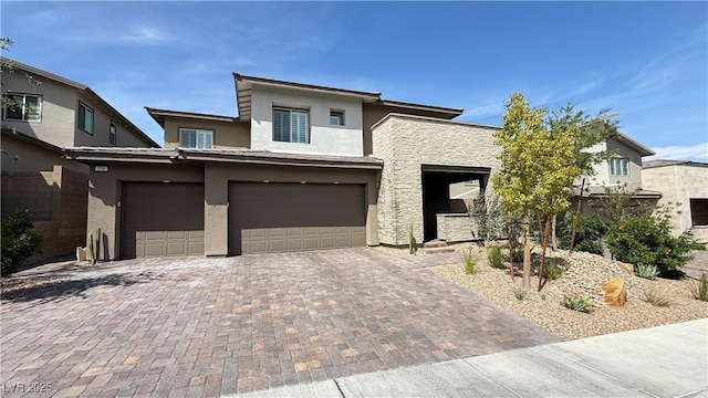 754 Agate Hills St, Las Vegas, NV 89138 - view of front of property featuring stucco siding, a garage, and decorative driveway