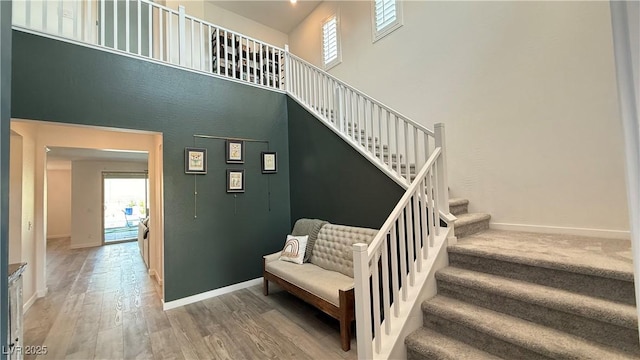 754 Agate Hills St, Las Vegas, NV 89138 - staircase with wood finished floors, a towering ceiling, and baseboards