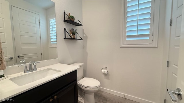 754 Agate Hills St, Las Vegas, NV 89138 - bathroom with baseboards, toilet, vanity, and wood finished floors