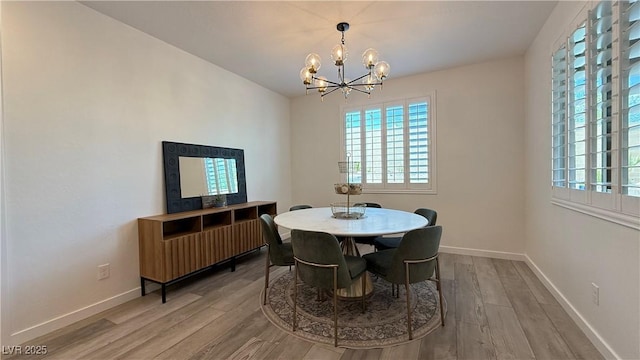 754 Agate Hills St, Las Vegas, NV 89138 - dining area with a chandelier, light wood-type flooring, and baseboards