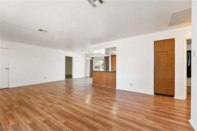 2440 Homestead Rd, Pahrump, NV 89048 - unfurnished living room featuring light wood-style floors and a chandelier