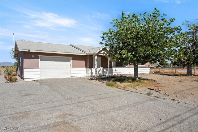 2440 Homestead Rd, Pahrump, NV 89048 - view of front facade featuring a garage and driveway
