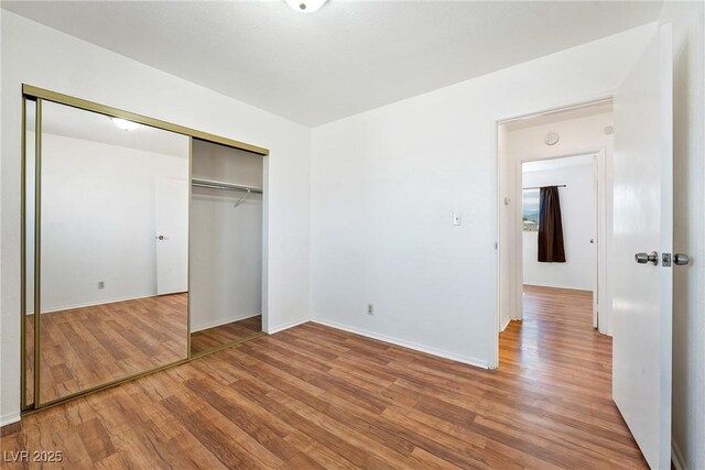 2440 Homestead Rd, Pahrump, NV 89048 - unfurnished bedroom with light wood-type flooring, a closet, and baseboards