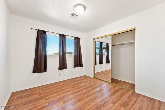 2440 Homestead Rd, Pahrump, NV 89048 - unfurnished bedroom featuring wood finished floors, a closet, and baseboards