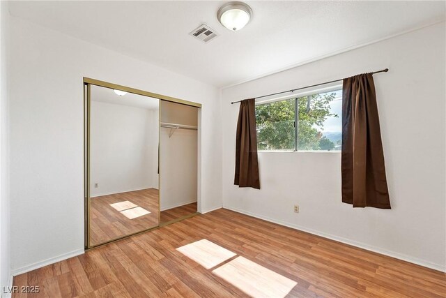 2440 Homestead Rd, Pahrump, NV 89048 - unfurnished bedroom featuring light wood-style floors, a closet, and baseboards