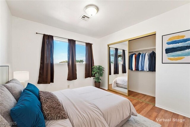 2440 Homestead Rd, Pahrump, NV 89048 - bedroom with light wood finished floors, a closet, and baseboards