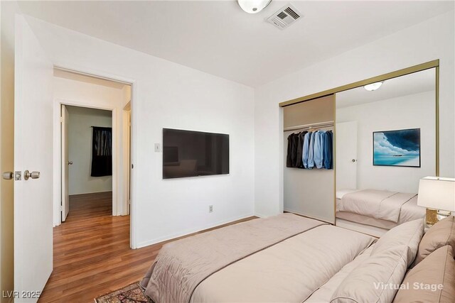 2440 Homestead Rd, Pahrump, NV 89048 - bedroom featuring wood finished floors, a closet, and baseboards