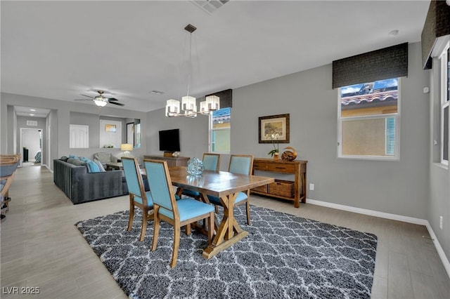 708 Kibbey St, Las Vegas, NV 89178 - dining area featuring a chandelier, baseboards, ceiling fan, and light wood-style floors