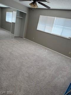 5389 Spencer St, Las Vegas, NV 89119 - unfurnished bedroom featuring carpet, baseboards, a closet, and a ceiling fan