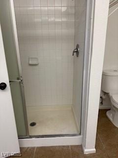 5389 Spencer St, Las Vegas, NV 89119 - bathroom with a stall shower, toilet, and tile patterned floors