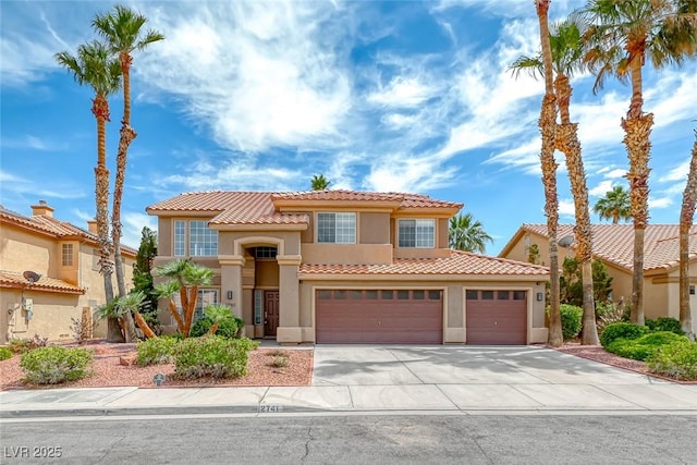 2741 Chokecherry Ave, Henderson, NV 89074 - mediterranean / spanish house with stucco siding, a tiled roof, and driveway