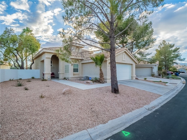 2521 Seascape Dr, Las Vegas, NV 89128 - mediterranean / spanish home with a tile roof, concrete driveway, stucco siding, and an attached garage