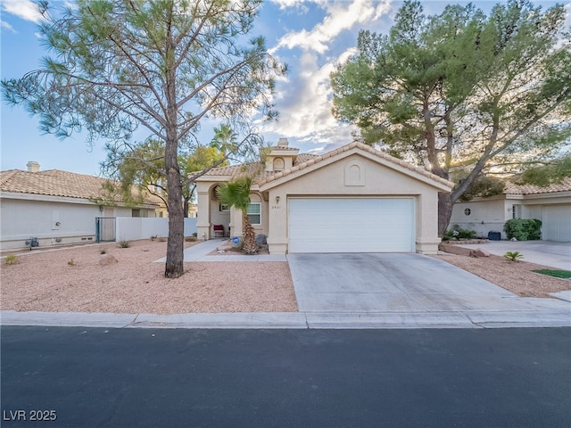 2521 Seascape Dr, Las Vegas, NV 89128 - mediterranean / spanish home with an attached garage, concrete driveway, stucco siding, a tile roof, and a chimney