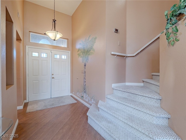 2521 Seascape Dr, Las Vegas, NV 89128 - entryway with wood finished floors, stairs, baseboards, and high vaulted ceiling
