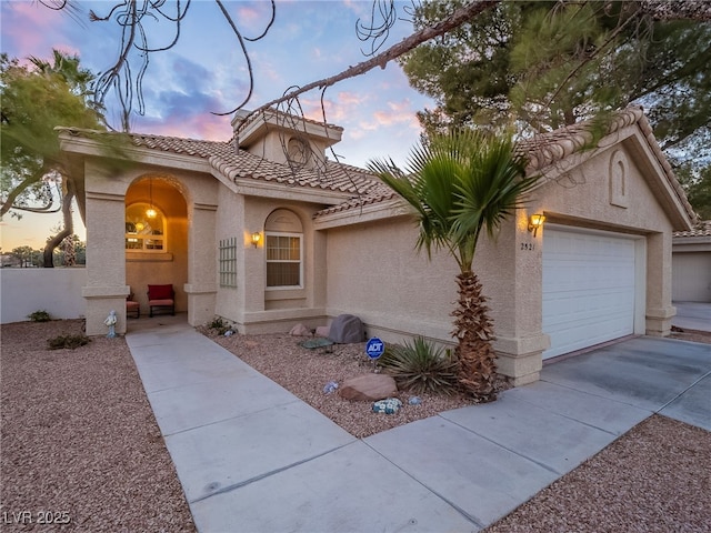 2521 Seascape Dr, Las Vegas, NV 89128 - mediterranean / spanish house with a tile roof, stucco siding, a garage, and driveway