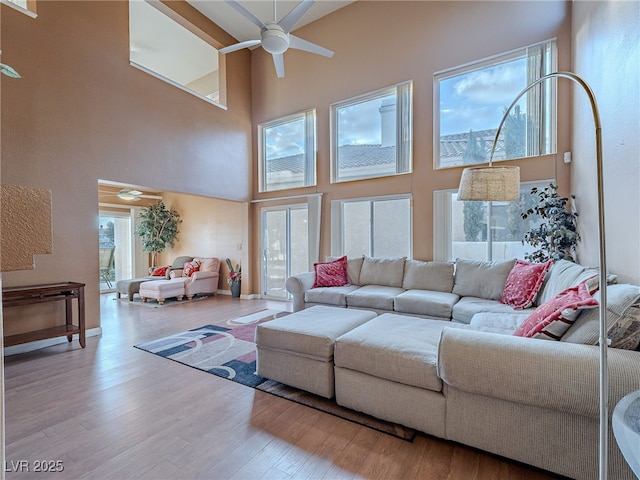 2521 Seascape Dr, Las Vegas, NV 89128 - living room featuring a ceiling fan, a towering ceiling, and wood finished floors