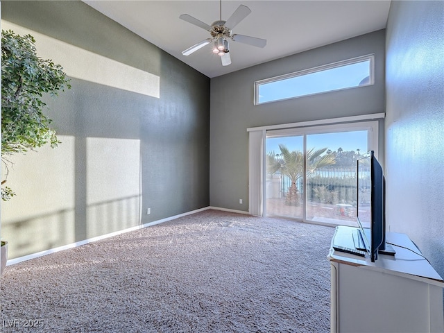 2521 Seascape Dr, Las Vegas, NV 89128 - carpeted spare room with a towering ceiling, ceiling fan, and baseboards