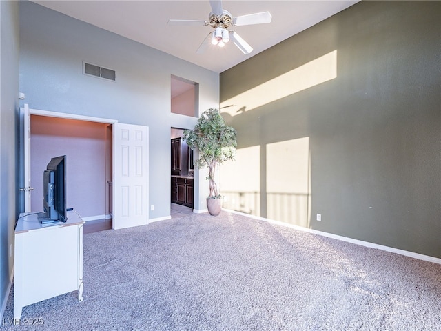 2521 Seascape Dr, Las Vegas, NV 89128 - spare room with carpet, a high ceiling, a ceiling fan, and baseboards