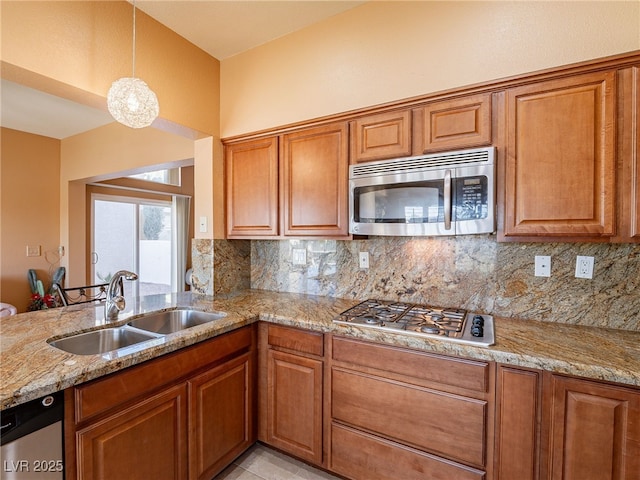 2521 Seascape Dr, Las Vegas, NV 89128 - kitchen with appliances with stainless steel finishes, a sink, light stone countertops, and decorative backsplash