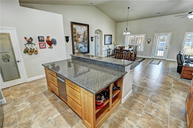 1361 Moose St, Pahrump, NV 89048 - kitchen with open shelves, arched walkways, baseboards, a ceiling fan, and a kitchen island
